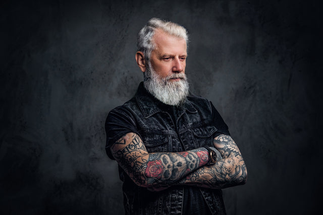 Gray-haired beardsman with tattoos - Lucky Boy Beard Company